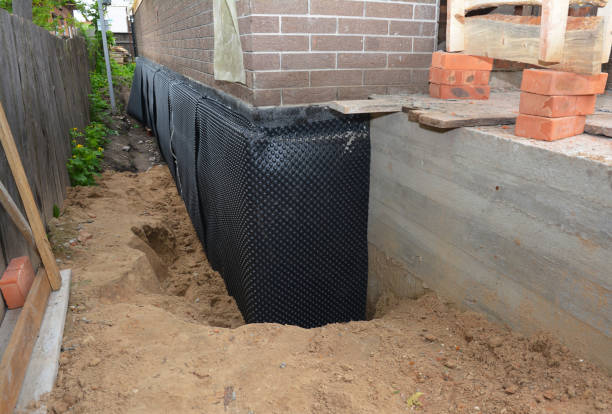 Happy homeowners after waterproofing job in Mound